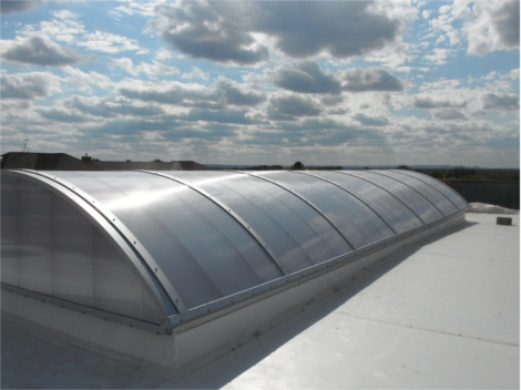 Exterior view of a white barrel vault skylight over hotel lobby