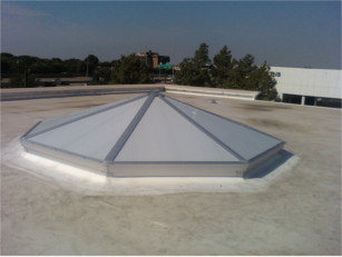 Exterior view of a white pyramid style CPI skylight over a store entrance