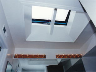 A bathroom naturally lit by frosted glass venting rooflight