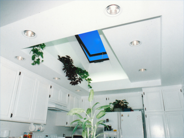A kitchen interior lit by a vented glass velux skylight