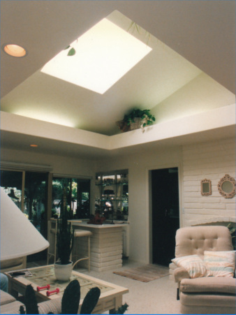 Inside of a living room with a large skylight shaft with lightshelf